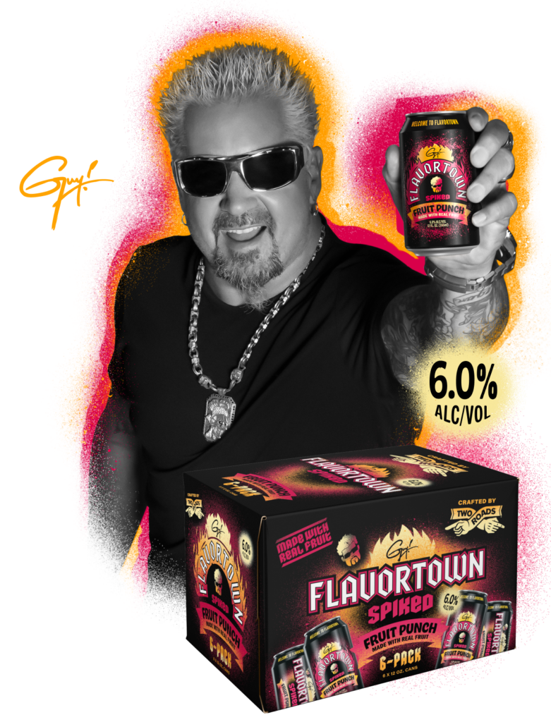 Guy Fieri holding Flavortown Spiked can with 6-pack